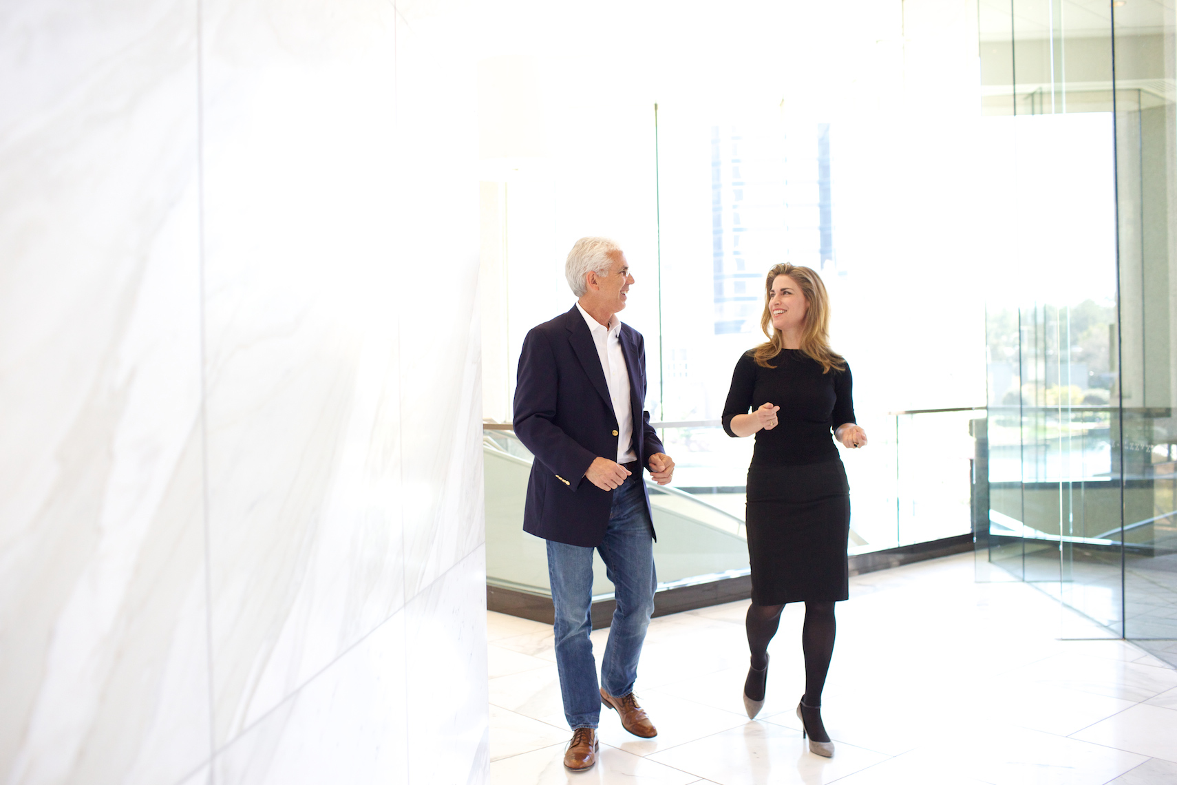 Corporate portrait photography Big Fish Studios man and woman walk and consult in lobby_Robert-Holland
